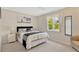 Cozy bedroom featuring plush carpet, neutral wall paint, and a large window letting in natural light at 9013 Nakoma Way, Weeki Wachee, FL 34613
