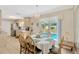 Bright dining area with a table set for six, with views of the pool outside the sliding glass doors at 9013 Nakoma Way, Weeki Wachee, FL 34613