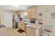 Well-lit kitchen featuring stainless steel appliances, neutral cabinets and tile backsplash at 9013 Nakoma Way, Weeki Wachee, FL 34613