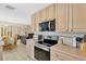 Modern kitchen with stainless steel appliances, light wood cabinets and an adjacent dining area at 9013 Nakoma Way, Weeki Wachee, FL 34613