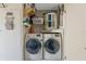 Laundry room featuring two front-load washing machines and shelving for storage at 9013 Nakoma Way, Weeki Wachee, FL 34613