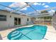 Capture this enticing screened-in pool showcasing a refreshing backyard oasis, perfect for cooling off on hot days at 9013 Nakoma Way, Weeki Wachee, FL 34613