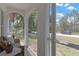 View from the screened-in porch overlooking a quiet neighborhood street with mature trees at 9013 Nakoma Way, Weeki Wachee, FL 34613
