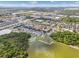 Wide aerial view of a residential area, lakes, ponds and lush landscapes under a sunny sky at 9031 Sienna Moss Ln, Riverview, FL 33578