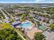 Aerial view of a community pool, splashpad, basketball court, and well-manicured landscaping at 9031 Sienna Moss Ln, Riverview, FL 33578