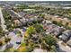 An aerial view of a neighborhood showcasing mature trees, a playground and well-maintained homes at 9031 Sienna Moss Ln, Riverview, FL 33578