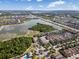 An aerial view of a sprawling community with multiple ponds, lush greenery, and well-maintained homes under a blue sky at 9031 Sienna Moss Ln, Riverview, FL 33578