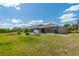 Large backyard features green grass and a seating area on the patio at 9031 Sienna Moss Ln, Riverview, FL 33578