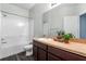 Bathroom with combination tub/shower, framed mirror and updated vanity at 9031 Sienna Moss Ln, Riverview, FL 33578