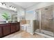 Luxurious bathroom with double vanity, soaking tub, and glass-enclosed shower at 9031 Sienna Moss Ln, Riverview, FL 33578