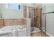 Bright bathroom features a separate shower with glass doors and a soaking tub at 9031 Sienna Moss Ln, Riverview, FL 33578