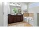Elegant bathroom with double sinks, granite countertops, soaking tub, and separate shower at 9031 Sienna Moss Ln, Riverview, FL 33578
