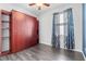 Bedroom with hardwood style floors and built in wood shelving and storage system at 9031 Sienna Moss Ln, Riverview, FL 33578