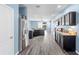 Modern kitchen with stainless steel appliances, granite countertops, and wood-look flooring at 9031 Sienna Moss Ln, Riverview, FL 33578