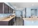 Modern kitchen with stainless steel appliances, granite countertops, and dark cabinetry at 9031 Sienna Moss Ln, Riverview, FL 33578