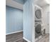 Efficient laundry area with stacked washer/dryer unit and utility sink at 9031 Sienna Moss Ln, Riverview, FL 33578