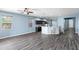 Spacious living area with open layout, featuring a kitchen with breakfast bar and ample natural light at 9031 Sienna Moss Ln, Riverview, FL 33578