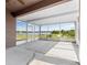 Screened patio overlooking a tranquil lake, offering serene outdoor living space at 9031 Sienna Moss Ln, Riverview, FL 33578