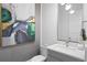 Stylish bathroom with modern fixtures, sleek vanity, and a unique piece of art enhancing the room's appeal at 916 Seagrape Dr, Ruskin, FL 33570
