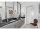 An elegant bathroom features dual sinks, gray cabinetry, and an open layout, creating a luxurious space at 916 Seagrape Dr, Ruskin, FL 33570