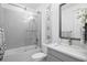 Bright bathroom with a shower and tub combination, granite countertops, and modern fixtures at 916 Seagrape Dr, Ruskin, FL 33570