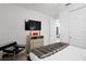 Bright bedroom with television, sleek furniture, and soft carpets at 916 Seagrape Dr, Ruskin, FL 33570