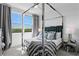 Large bedroom with a four post bed, beautiful views, and sleek decor at 916 Seagrape Dr, Ruskin, FL 33570