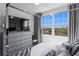 Bright bedroom featuring modern decor, large windows, and a stylish canopy bed frame at 916 Seagrape Dr, Ruskin, FL 33570
