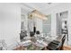 Elegant dining area with a crystal chandelier, glass table, and view of the staircase at 916 Seagrape Dr, Ruskin, FL 33570