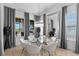 Bright dining area features a glass table, stylish chairs, and elegant curtains at 916 Seagrape Dr, Ruskin, FL 33570