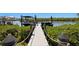 Picturesque dock featuring sturdy pillars with rope accents, boat lifts, and lush greenery, perfect for waterfront living at 916 Seagrape Dr, Ruskin, FL 33570