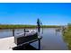 Waterfront home featuring a beautiful dock with comfortable outdoor seating, perfect for enjoying the stunning waterfront views at 916 Seagrape Dr, Ruskin, FL 33570
