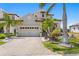 Beautiful home with a two-car garage, manicured landscaping, and a brick driveway at 916 Seagrape Dr, Ruskin, FL 33570