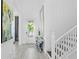 Bright foyer with staircase, modern decor, and ceramic tile flooring at 916 Seagrape Dr, Ruskin, FL 33570