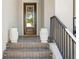 Inviting front porch and stairs with decorative planters leading to the front door at 916 Seagrape Dr, Ruskin, FL 33570