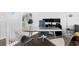 Upstairs landing features a fun, modern home office space and dark hardwood flooring at 916 Seagrape Dr, Ruskin, FL 33570