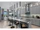 A beautifully appointed kitchen features gray cabinetry, stone countertops, pendant lighting and stainless steel appliances at 916 Seagrape Dr, Ruskin, FL 33570