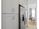 Modern kitchen with stainless steel appliances, sleek white cabinets, and a view into the elegant dining area at 916 Seagrape Dr, Ruskin, FL 33570
