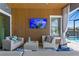 Charming lanai featuring comfortable seating, a mounted TV, and access to the pool area at 916 Seagrape Dr, Ruskin, FL 33570