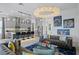 Open concept living space with view of the kitchen, fireplace, and tufted sofas at 916 Seagrape Dr, Ruskin, FL 33570