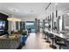 Open-concept living room with modern furnishings, a kitchen bar, and access to the pool area at 916 Seagrape Dr, Ruskin, FL 33570