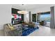 Stylish living room showcasing elegant sofas, a fireplace, and sliding glass doors to the outdoors at 916 Seagrape Dr, Ruskin, FL 33570