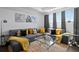 Open living room features a large comfortable couch, grey curtains, and lots of natural light at 916 Seagrape Dr, Ruskin, FL 33570