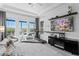 This spacious main bedroom features multiple windows with waterfront views and a stylish media center at 916 Seagrape Dr, Ruskin, FL 33570
