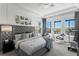 This elegant main bedroom has a tufted headboard, river views, and seating at 916 Seagrape Dr, Ruskin, FL 33570