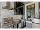 Close-up of the outdoor kitchen with stainless steel appliances and stylish backsplash at 916 Seagrape Dr, Ruskin, FL 33570