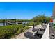 Cozy patio area with lounge chairs and lush vegetation, offering a tranquil view of the waterfront and boat dock at 916 Seagrape Dr, Ruskin, FL 33570