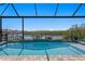 Beautiful pool with a serene waterfront view and a clear blue sky above at 916 Seagrape Dr, Ruskin, FL 33570