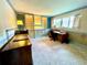 Home office with built-in shelving, desk, chair, carpeted floor, and natural light at 924 Highview Dr, Palm Harbor, FL 34683