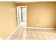 Neutral room with tile floor, light walls, and a doorway to another room with natural light at 924 Highview Dr, Palm Harbor, FL 34683